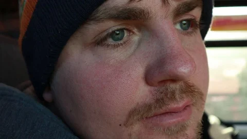 The eye twitches. The guy rides on the train and looks out the window. Addict Video stock 124559089