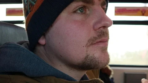 The eye twitches. The guy rides on the train and looks out the window. Addict 動画素材 124559144