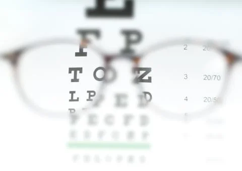 Eye vision test chart seen through eye glasses. Prescription glasses sitting  写真素材
