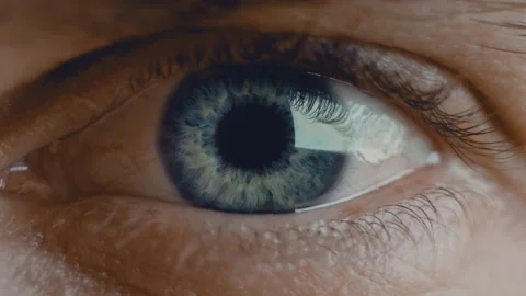 Eyeball is moving side to side. Young man blue iris eye macro shot. Healthy Stock Footage 136472774