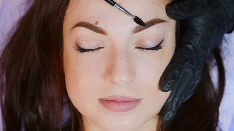 The eyebrow is brushed by the master after the microblading. Stock Footage 115850392