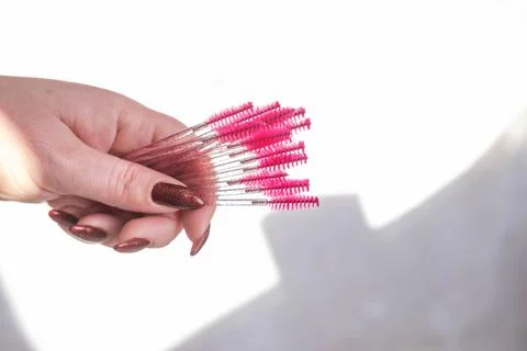 Eyebrow combing brushes in hand Stock Photos