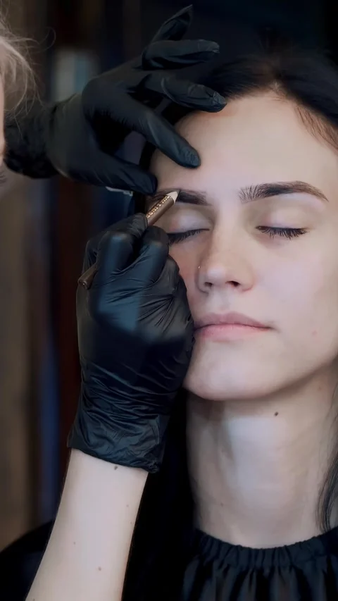 Eyebrow correction. cosmetologist, brow maker, master in black rubber gloves, Stock Footage 311319090