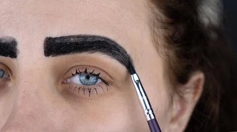 Eyebrow correction procedure close up Stock Photos