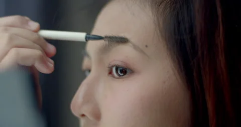 Eyebrow gel is applied to the eyebrows and then combed to make the eyebrows easy Stock Footage 310015676