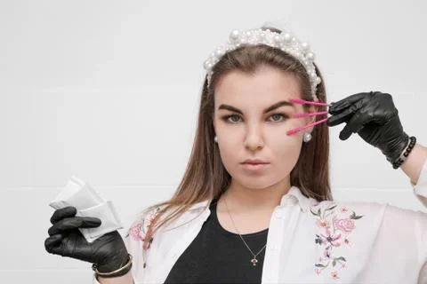 Eyebrow master girl on white wall background Photos