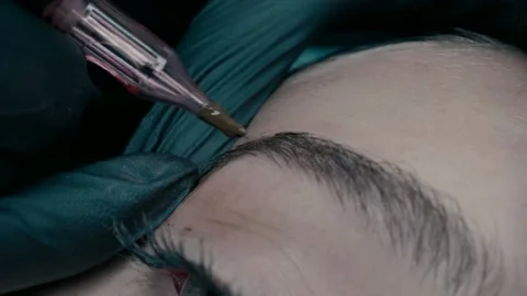 An eyebrow master at microblading work makes a pigment on the eyebrow. Stock Footage 223155673