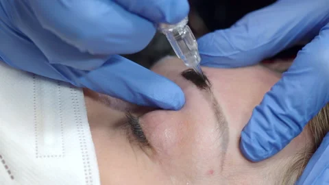 Eyebrow microblading is done with a motor with a blade Stock Footage 153216326