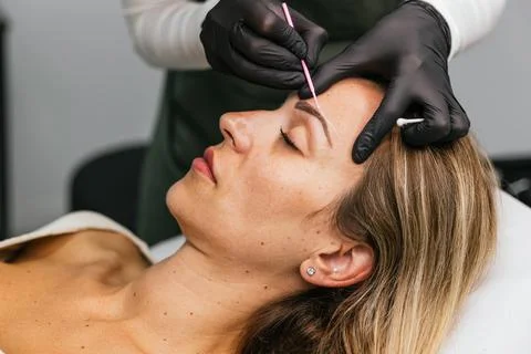 Eyebrow shaping preparation for microblading procedure Stock Photos