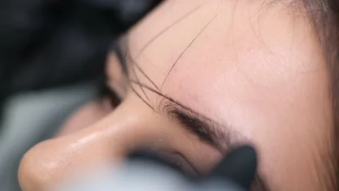 Eyebrow threading is a hair removal procedure to correct the shape of the Stock Footage 224355154