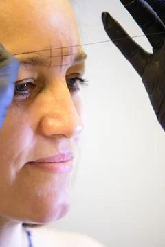 Eyebrow Threading Preparation for micro blading treatment Stock Photos