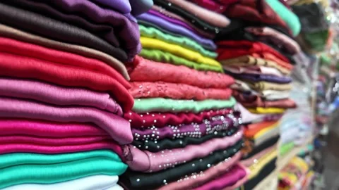 An EyeCatching Stack of Vibrant Textiles on Display in a Market Setting Stock Footage 303880678