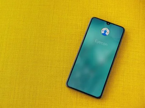 Eyecon app launch screen with logo on the display of a black mobile smartphon Stock Photos