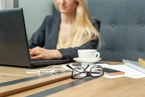 Eyeglass with coffee on office table. Stock Photos