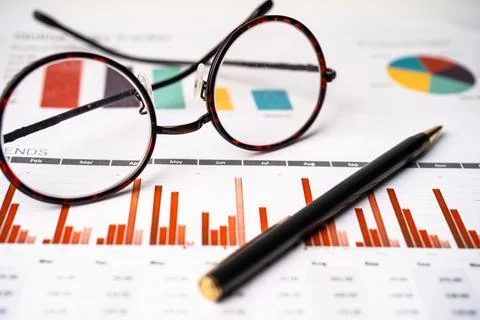 Eyeglass on graph paper background. Stock Photos