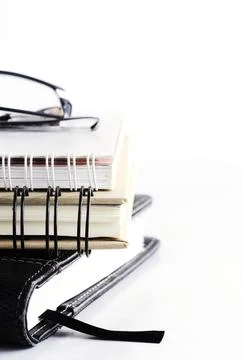 Eyeglass on top books stack on Vertical side for education concept Stock Photos