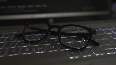 Eyeglass viewing on the laptop keyboard Stock Footage 290944606