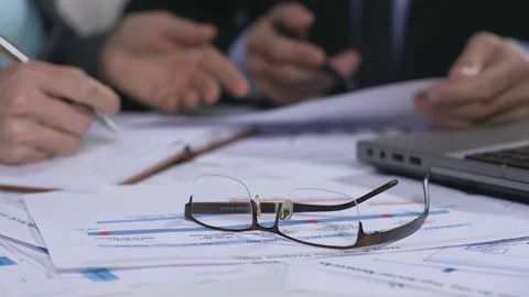 Eyeglasses and documents lying on table, business meeting, analysis of data Stock Footage 83634182