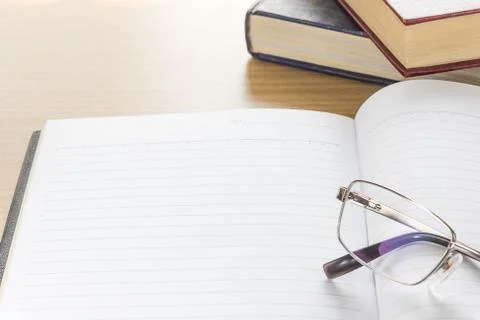 Eyeglasses and Notepad with blank page Stock Photos