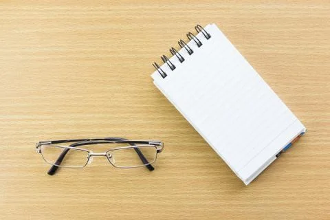 Eyeglasses and Notepad with blank page Stock Photos