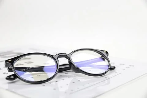 Eyeglasses on blur chart Stock Photos