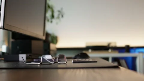 Eyeglasses on computer desk. Video stock 220452212