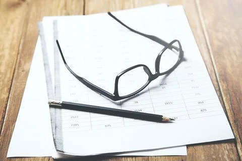 Eyeglasses  on document on table Stock Photos