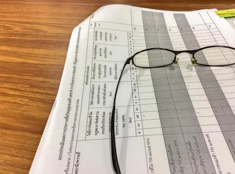 Eyeglasses on documents Stock Photos