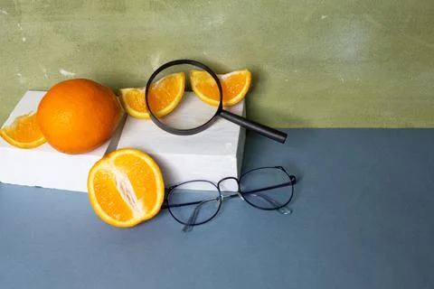 Eyeglasses, glasses in thin, black frames with oranges and a magnifying gla.. Foto stock