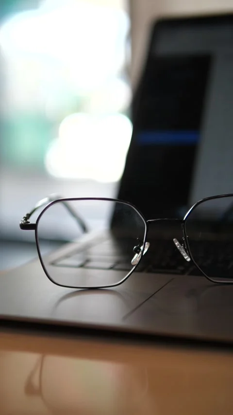 Eyeglasses on laptop with blurred background Stock Footage 320768848