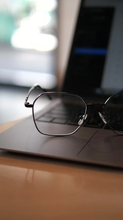 Eyeglasses on laptop with blurred background Stock Footage 320768850