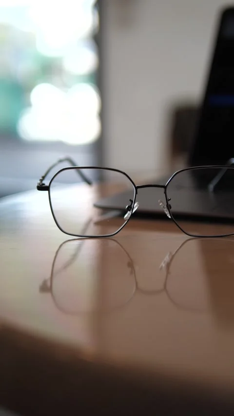 Eyeglasses on laptop with blurred background Stock Footage 320768860