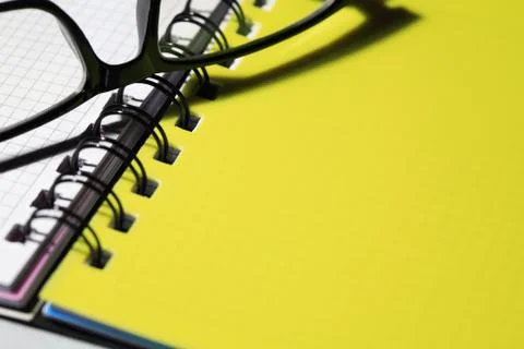 Eyeglasses on notebook Stock Photos