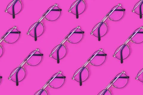Eyeglasses pattern on a purple background. Stock Photos