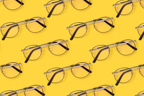 Eyeglasses pattern on a yellow background. Stock Photos