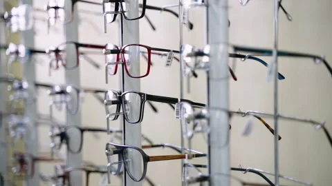 Eyeglasses rotating on display stand in optical store Stock Footage 310811371