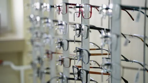 Eyeglasses rotating on display stand in optical store Video stock 310811409