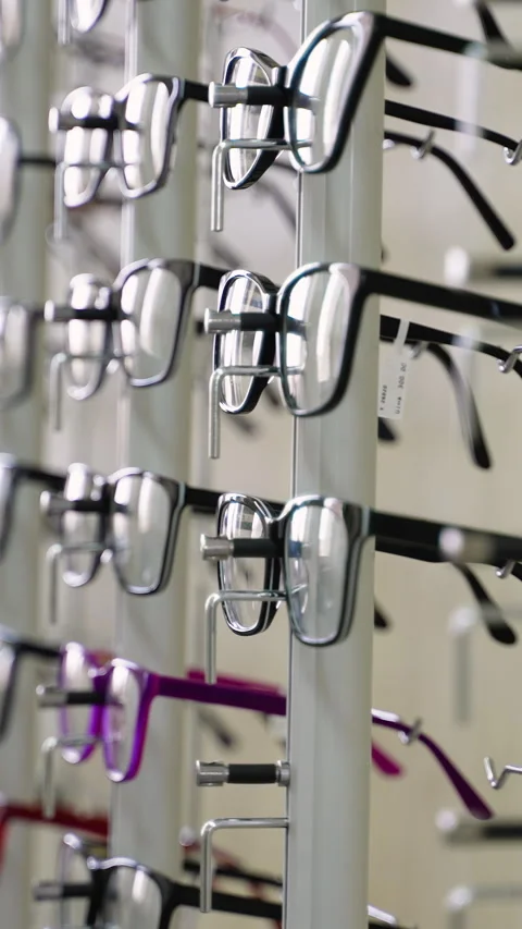 Eyeglasses rotating display stand in optical store Stock Footage 310812204