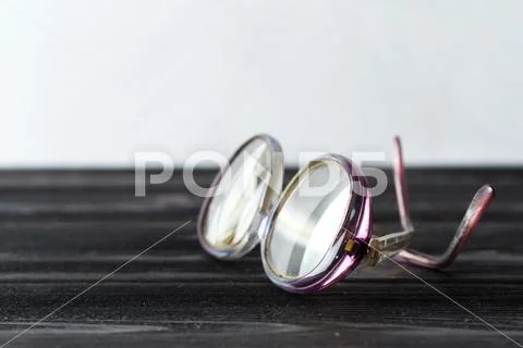 Eyeglasses on wooden table Stock Photos