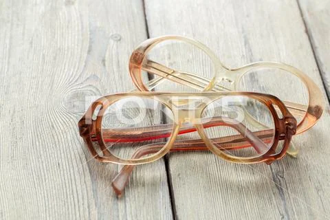 Eyeglasses on wooden table Stock Photos