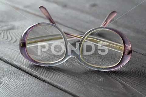 Eyeglasses on wooden table Stock Photos