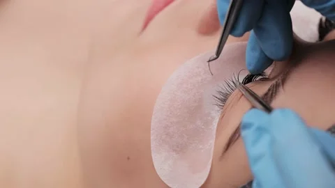 Eyelash extension procedure. The working process of professional beauty master Stock Footage 195995736