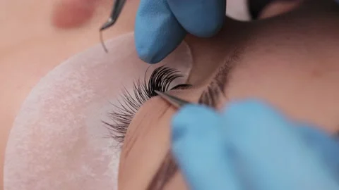Eyelash extension procedure. The working process of professional beauty master Stock Footage 237463502