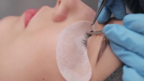 Eyelash extension procedure. The working process of professional beauty master Stock Footage 268762301
