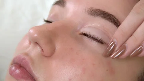 Eyelash lamination procedure. The master glues the eyelash curler. Close-up Video stock 156392443