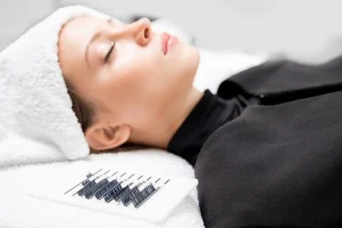 Eyelashes extensions. Lash extension procedure in spa beauty salon Stock Photos