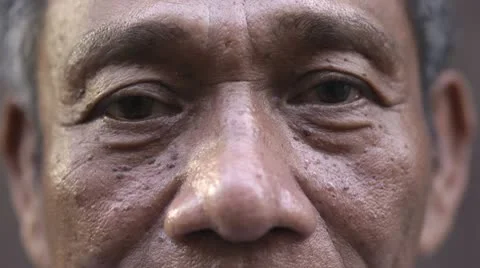 Eyes and face of serious old asian man looking at camera Stock Footage