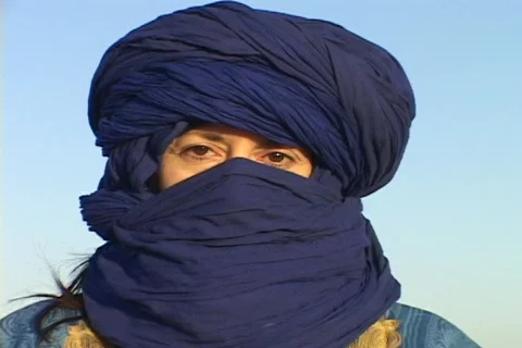 The eyes of an Arab woman show through her blue abaya. Stock Footage