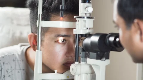 Eyes being checked on a optical computerized autorefractor machine, close Stock Footage 112428932