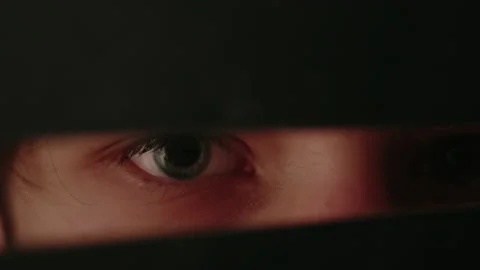 Eyes of a boy watching through a gap Stock-Footage 235930468